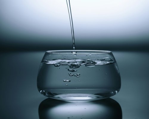 Pouring water into a glass